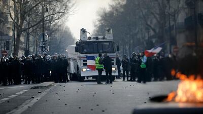 Demonstrators face police officers during minor clashes with police in Paris, Saturday, March 23, 2019. The French government vowed to strengthen security as yellow vest protesters stage a 19th round of demonstrations, in an effort to avoid a repeat of last week's riots in Paris. AP