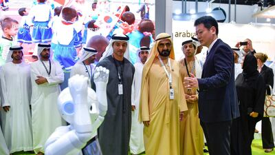Sheikh Mohammed, Sheikh Mansour and Sheikh Hazza are shown a robot at ADSW on Wednesday. Wam