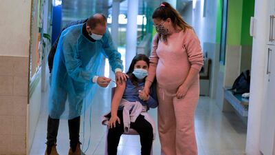 An Israeli child is inoculated. Last month, Israel began offering vaccines to younger children between the ages of 5 and 12, but the authorities say the vaccination rate in that age group remains disappointingly low. Photo: AFP