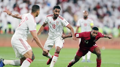 UAE's Khamis Esmail vies for the ball with Qatar's Salem Al Hajri during their Asian Cup semi-final in Abu Dhabi on Tuesday. All photos by Chris Whiteoak / The National