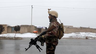 An Afghan security force member stands guard near the site of an attack at the Marshal Fahim military academy in Kabul. Reuters