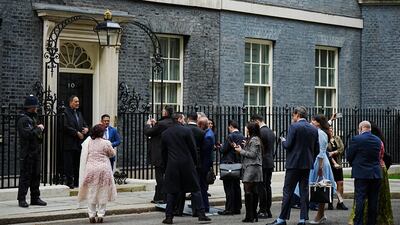 Members of the Muslim community queue to have their pictures taken in front of 10 Downing Street in London, as they arrive for an Eid reception on April 15. PA