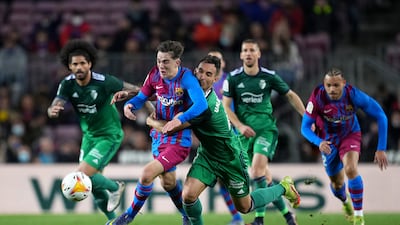 Barcelona midfielder Gavi is challenged by Unai Garcia of Osasuna. Getty