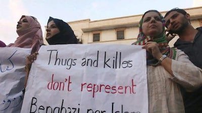 Demonstrators in Benghazi hold a message during a rally to condemn the killers of the US ambassador to Libya, J Christopher Stevens, and the attack on the US consulate.