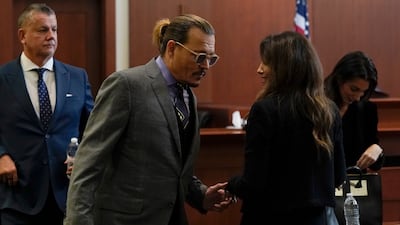 Depp greets his legal team as he arrives at Fairfax County Circuit Court, where he is suing his ex-wife for libel. EPA