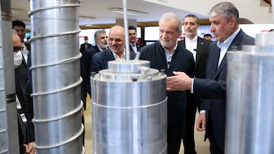 Mohammed Eslami, right, head of the Iranian Atomic Energy Organisation, shows Iran's President Masoud Pezeshkian, second right, part of an exhibition in Tehran. EPA