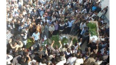 Anti-government protesters attend the funeral of Sunni Muslim villagers killed on Wednesday near Homs. Syrian activists said that security forces shot dead at least 11 villagers at a roadblock near Homs.