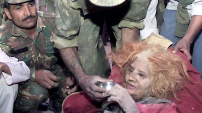 A 75-year-old Indian woman, Pokanaseri, is offered tea by a soldier after she was pulled out from the rubble of her home in the western Indian city of Bhuj January 27, 2001. Reuters