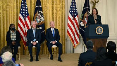 Natasha Jackson, a business owner and A Better Balance Community advocate, watches with former US president Bill Clinton and President Joe Biden as Vice President Kamala Harris speaks. AFP