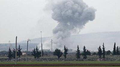 A picture taken from the town of Sarmin in north-western Syria on Friday shows smoke billowing over the village of Qaminas, near Idlib. AFP