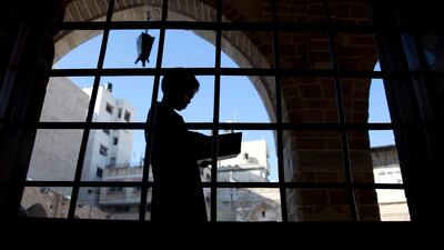 A Palestinian boy reads verses of the Quran at Al Omari mosque in Gaza City. AP Photo