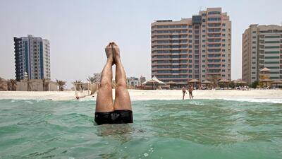 Ajman, August 10, 2011 - Sometimes the only way to escape temperatures of 42 degrees Celsius is to go underwater as Alex Rajsic does off the beach in Ajman. (Jeff Topping/The National)