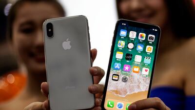 Taiwanese women hold the new Apple iPhone X at an Apple store in Taipei, Taiwan. EPA