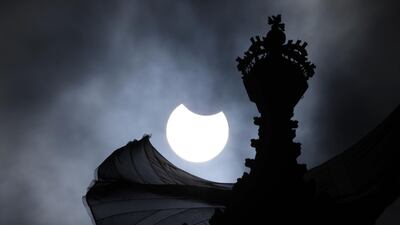 A partial solar eclipse is seen over the Houses of Parliament in London, England. Getty Images
