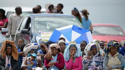 People watch big screens at the site of where Mandela will be buried. Jeff J Mitchell / Getty Images