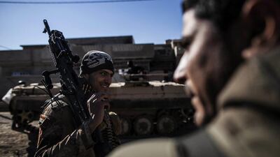 An Iraqi soldier from the 9th Infantry Division holds his machine gun while heading to the frontline in Shyma district in Mosul, Iraq. Manu Brabo / AP Photo