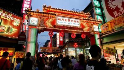Residents throng a brightly lit bazaar in Tai Pei - one of the 20 night markets in the busy city. Maurice Tsai / Bloomberg