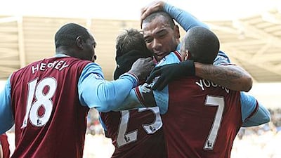 John Carew, second right, is mobbed by his teammates after his hat-trick goal.