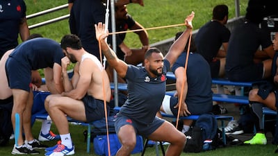 France's loose head prop Jefferson Poirot stretches before a training session. AFP