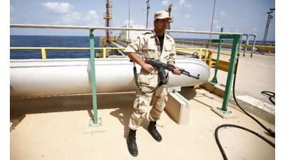 An anti-Gaddafi fighter stands guard at the Mellitah Oil and Gas complex during a handover ceremony in Mellitah, 80km west Tripoli this week. Reuters