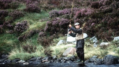 Britain's King Charles III, seen here fishing in the River Dee in 1982, is among those alarmed by the threat to the salmon population in Scotland. Getty Images
