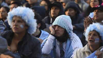 Fans of Argentina watch the World Cup match between Argentina and Croatia on a giant screen at San Martin square in Buenos Aires. Eitan Abramovich / AFP