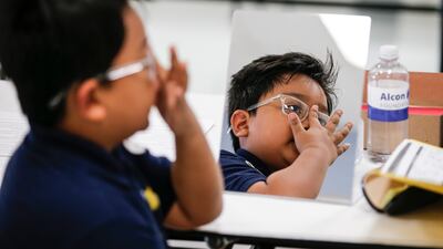 A child receives prescription glasses on World Sight Day in Texas. This year, a bill was introduced in Congress that called for mandatory eye checks for young children. AP