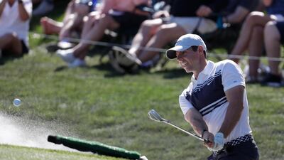 Rory McIlroy hits from a bunker on the ninth. AP