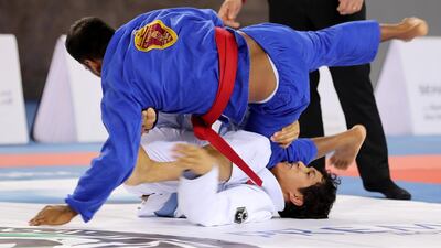 Ahmed Khamis Aljunaibi ( blue ) of Al Wahda Club and Naser Al Breiki ( white ) of A.F.N.T during the men seniors category game in the Jiu-Jitsu President’s Cup Round -1 held at Al Jazira Club Indoor stadium in Abu Dhabi. Naser Al Breiki won the game. Pawan Singh / The National