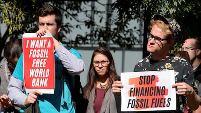 Protestors outside the World Bank demonstrate against financing fossil fuels and demanding investment in renewable energy, during the IMF and World Bank's 2019 annual meetings of finance ministers and bank governors, in Washington. Reuters