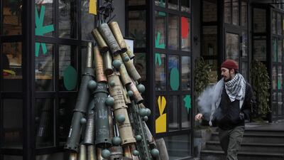 A man passes by a symbolic Christmas tree made from used artillery shells transported to the Ukrainian capital from the front line, Kyiv, Ukraine. Reuters