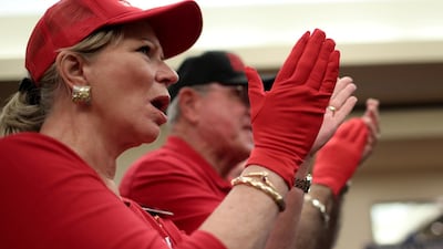 Supporters of Ted Cruz applaud wearing 'Red Wave' gloves at a campaign rally in Victoria, Texas. Reuters