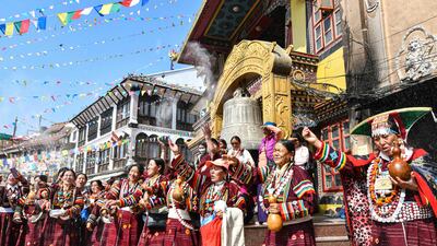 Nepalis throw flour at the Boudhanath Stupa temple in Kathmandu on the third day of the Nepali Buddhist and Tibetan New Year. AFP
