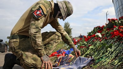 A Wagner fighter visits a makeshift memorial to Yevgeny Prigozhin in St Petersburg, Russia. Reuters