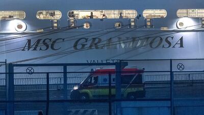 An ambulance near the 'MSC Grandiosa' cruise ship which docked in Genoa on Monday. EPA