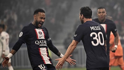PSG forward Neymar, left, congratulates teammate Lionel Messi on his goal against Lyon. AFP