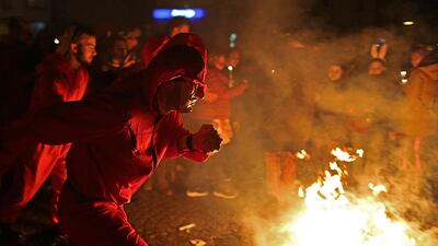 Revellers dance around a burning straw doll at the traditional end of the carnival on Ash Wednesday, in Cologne, Germany. AP Photo