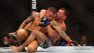 Dustin Poirier and Michael Chandler fight during their lightweight fight at UFC 281. AFP