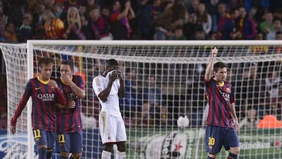 Lionel Messi, right, following his spot-kick goal in Barcelona's 3-1 win over Milan on Wednesday night. Manu Fernandez / AP
