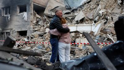 Residents gather at the site of a Russian strike on Kyiv. Reuters