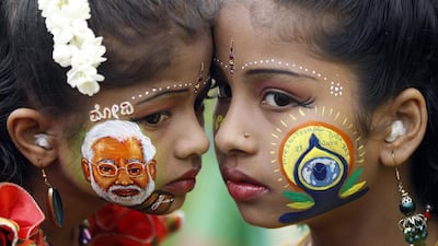 India’s bright future? A young girl sports the image of Narendra Modi during International Yoga Day in Bangalore on Sunday. AP Photo / Aijaz Rahi