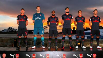 Arsenal players Laurent Koscielny, Petr Cech, Alex Lacazette, Olivier Giroud, Mesut Ozil and Nacho Monreal model the team's new third kit for the 2017/2018 season in front of the Opera House and Harbour Bridge in Sydney, Australia, July 12, 2017.