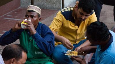 Men break their fasts and share food at Jumeirah Grand Mosque in Dubai on the first day of Ramadan. Duncan Chard for The National