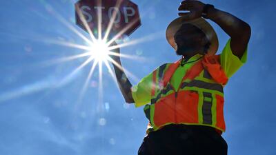 Traffic warden Rai Rogers works on his street corner under the hot sun in Las Vegas. AFP