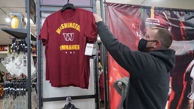 A shopper inspects a new Washington Commanders t-shirt. Willy Lowry / The National.