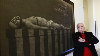 Syrian artist Youssef Abdelke stands near his artwork during an exhibition at a gallery in Beirut on January 6. Abdelke has been touring the Middle East with his work but he always returns, doggedly, to his base in Damascus. Jamal Saidi / Reuters