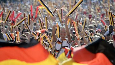 Fans watching the European Championship group C soccer match between Germany and Northern Ireland played at the Parc des Princes stadium in Paris, France, at the fan zone at Brandenburg Gate in Berlin, Germany, Tuesday June 21, 2016. (Maurizio Gambarini/dpa via AP)