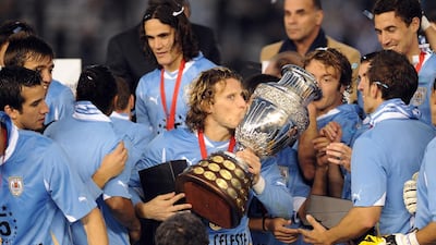 Forlan kisses the Copa America trophy after winning the 2011 Copa America football tournament at the Monumental stadium in Buenos Aires, on July 24, 2011. Juan Mabromata / AFP