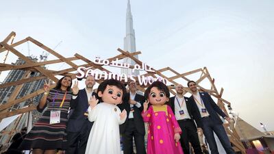 People have their picture taken with Rashid and Latifa - official Expo 2020 mascots.