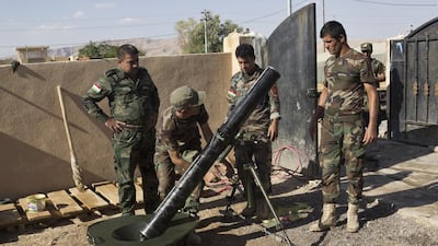 Kurdish peshmerga check to see if an US-made M120 mortar can still be used.
